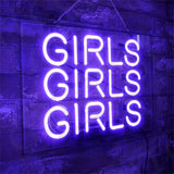 Bright purple neon sign displaying the word 'GIRLS' repeated three times in uppercase letters, mounted on a dark textured wall with a hanging chain.