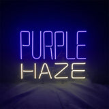 Neon sign with the words 'PURPLE' in purple light and 'HAZE' in yellow light against a dark background.
