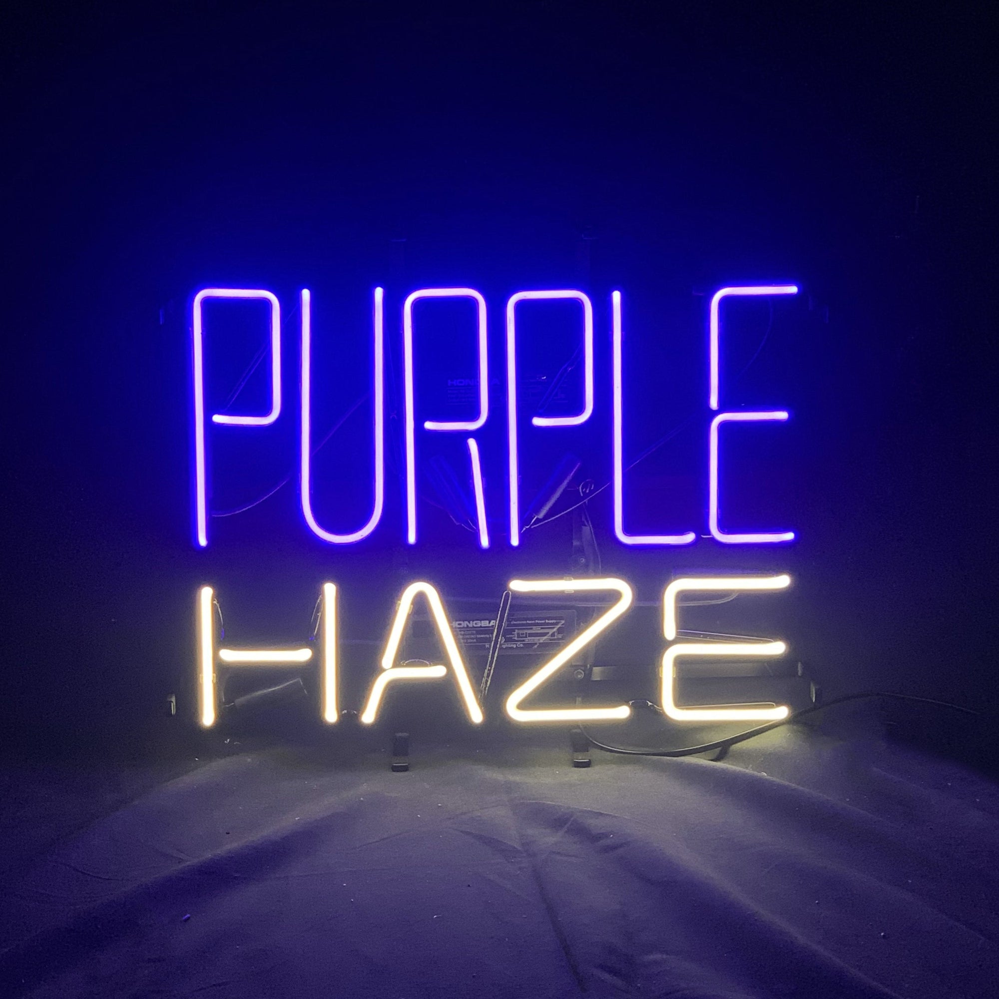 Purple Haze Beer Neon Sign Light glowing in purple on metal grid backing