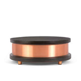 Circular low table with dark wood top and base, featuring a wide polished copper band around the middle and small copper cylindrical feet.