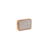 Rectangular wooden box with rounded edges featuring a brushed metal top engraved with a stylized letter Q in a gold tone.