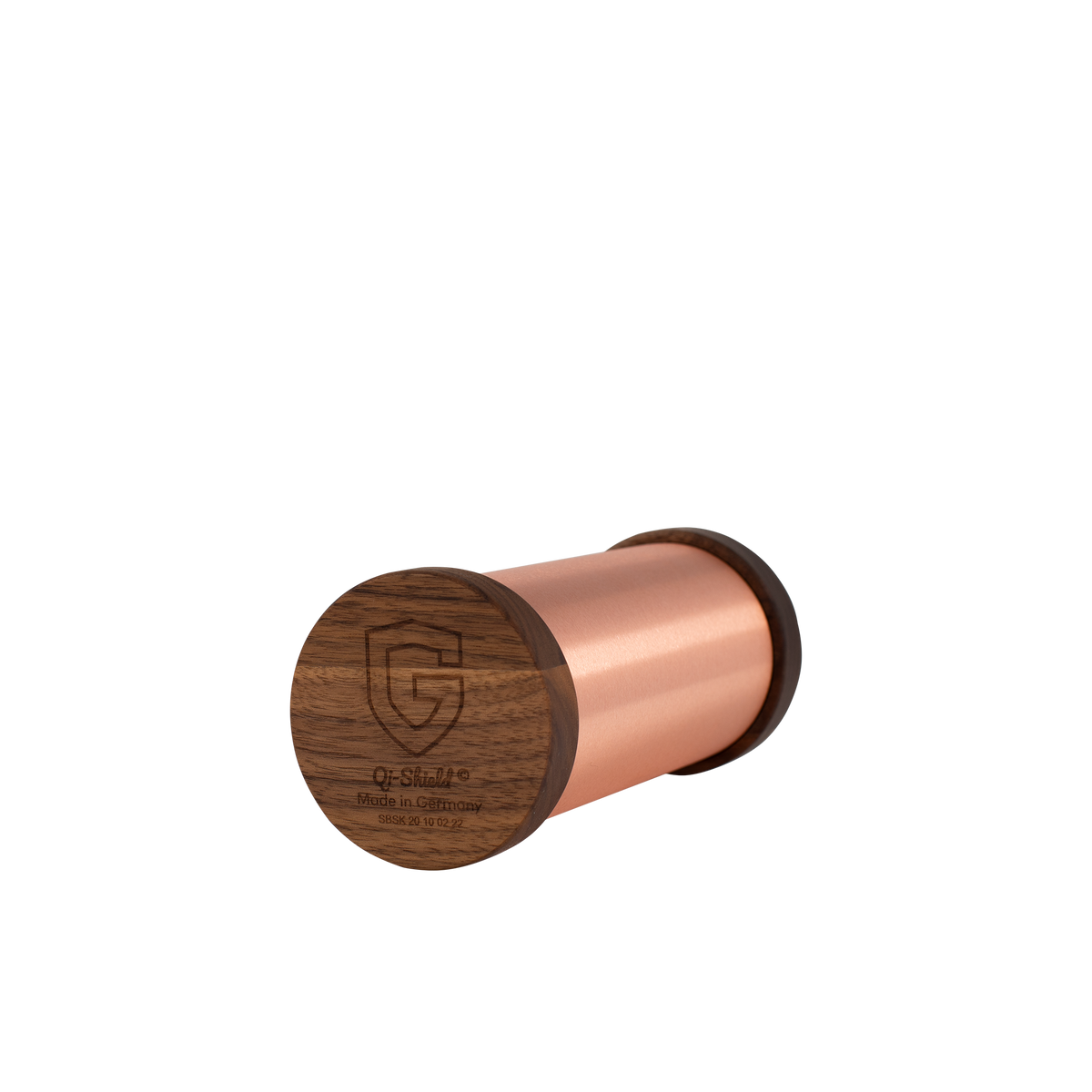 Cylindrical copper Qi-Shield device with dark wood end cap engraved with a shield logo and text, shown on a white background.