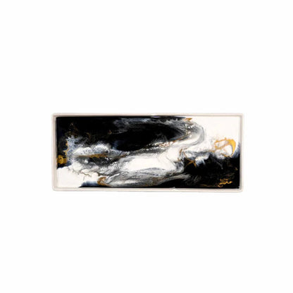 Abstract resin ceramic tray with black, white, and gold colors on a white background