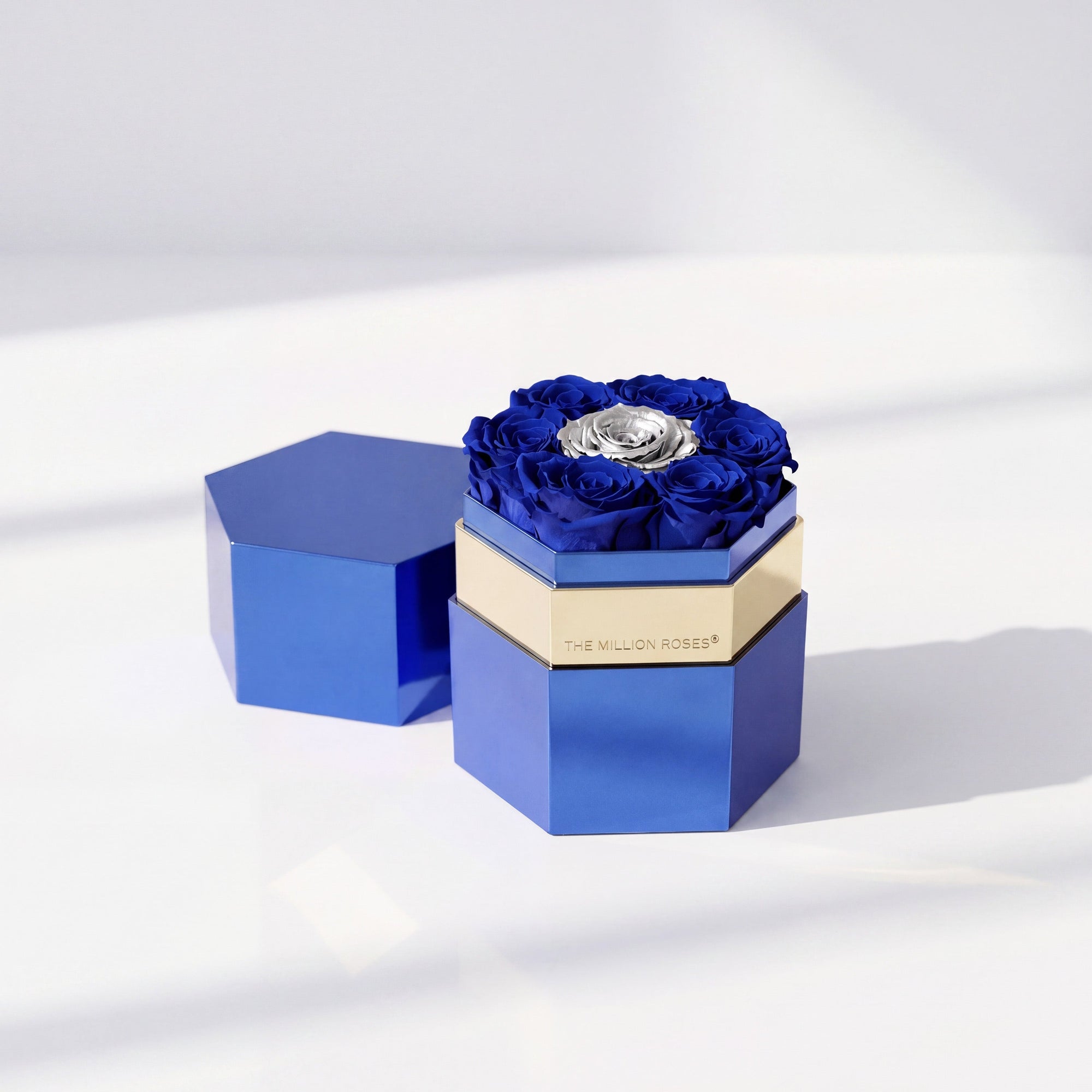 Hexagonal box with a single dark blue and silver rose displayed inside