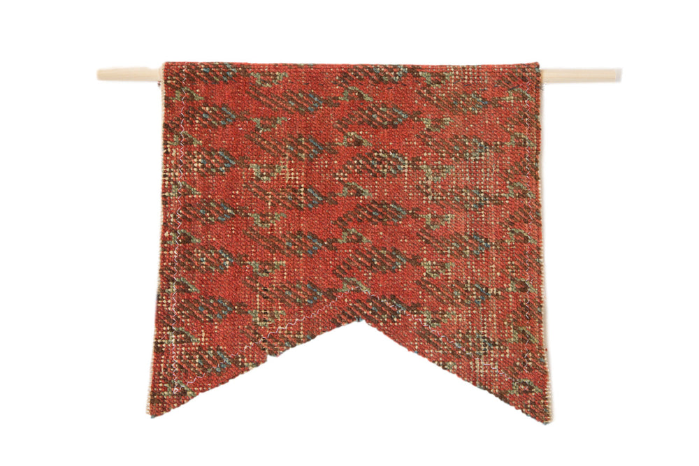 Limited edition RUGLING 01 wall hanging showing antique Mir Serbend Persian rug fragment mounted on a cork board with wooden dowels for hanging.
