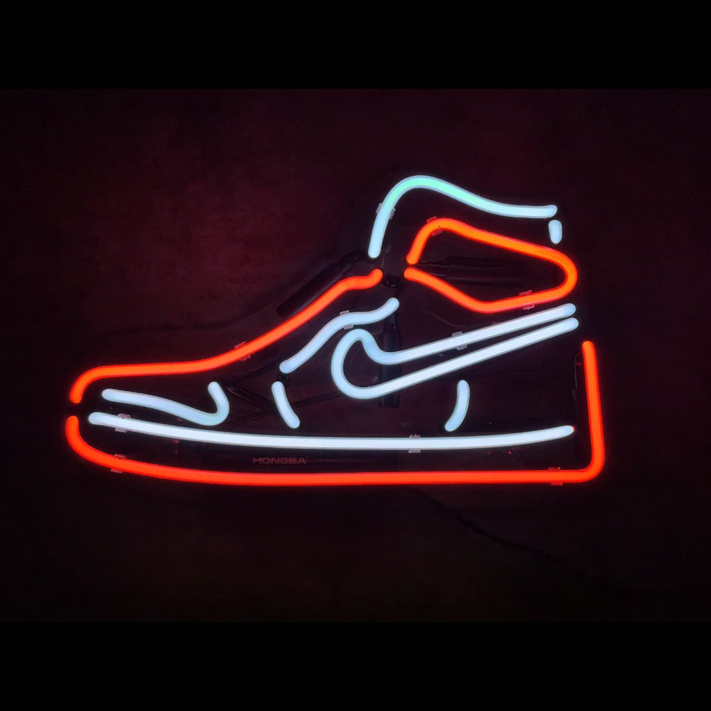Red Sneaker Neon Signs Light glowing red against a dark background