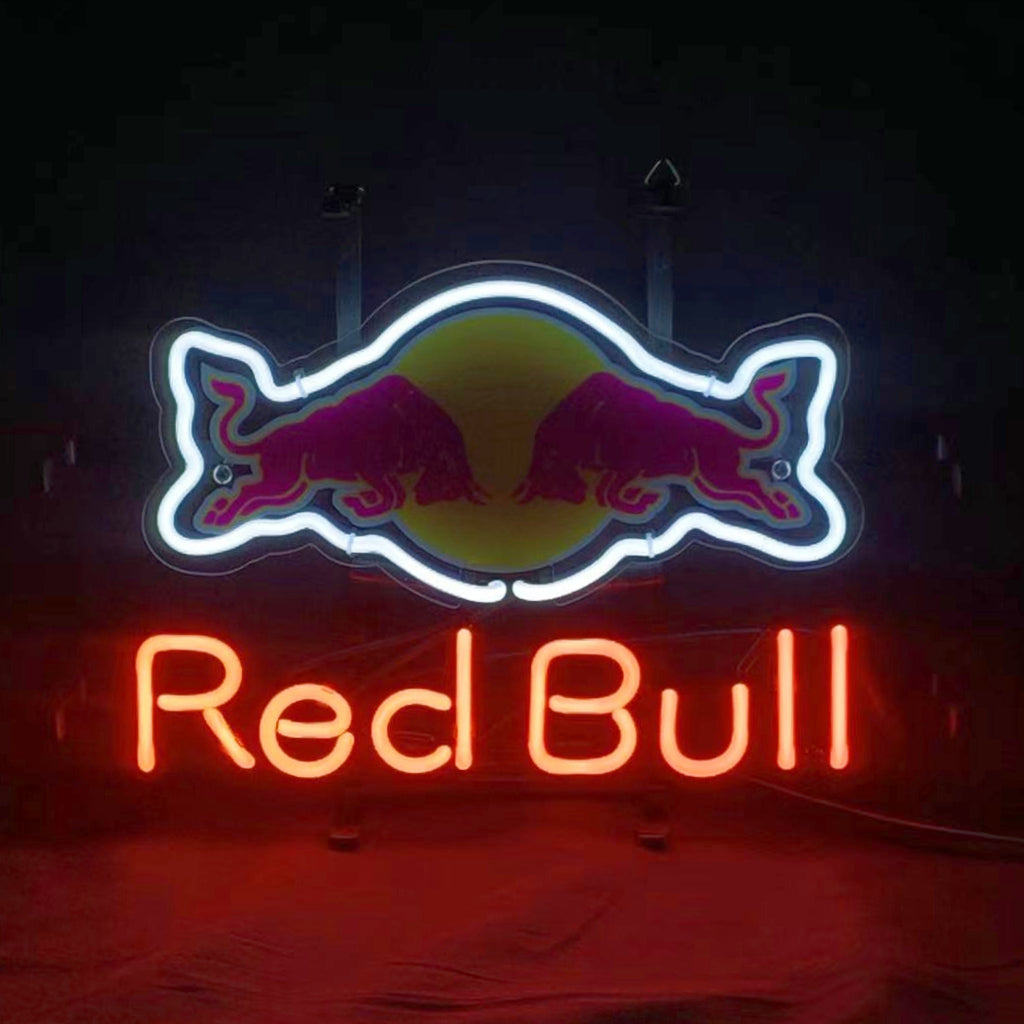 Neon sign of two red bulls facing each other over a yellow circle outlined in white, with 'Red Bull' written below in red neon letters on a black background.