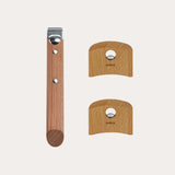 Set of three wooden kitchen handles: one long rectangular handle with metal end and two smaller half-circle handles with metal centers, all light brown wood marked Cristel.