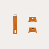 Set of three orange resin handles with silver rectangular accents, featuring one long curved piece and two smaller square pieces with curved edges, displayed on a pale background.