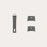 Set of three matte gray cabinet handles with rectangular cutouts and small metallic clip accents, shown on a light neutral background.