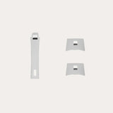 Three white plastic knife handles including one long rectangular and two shorter curved pieces, each with a square cutout near the center.