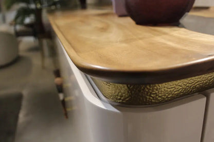 Modern resin and walnut credenza with aluminum legs in a stylish living room setting