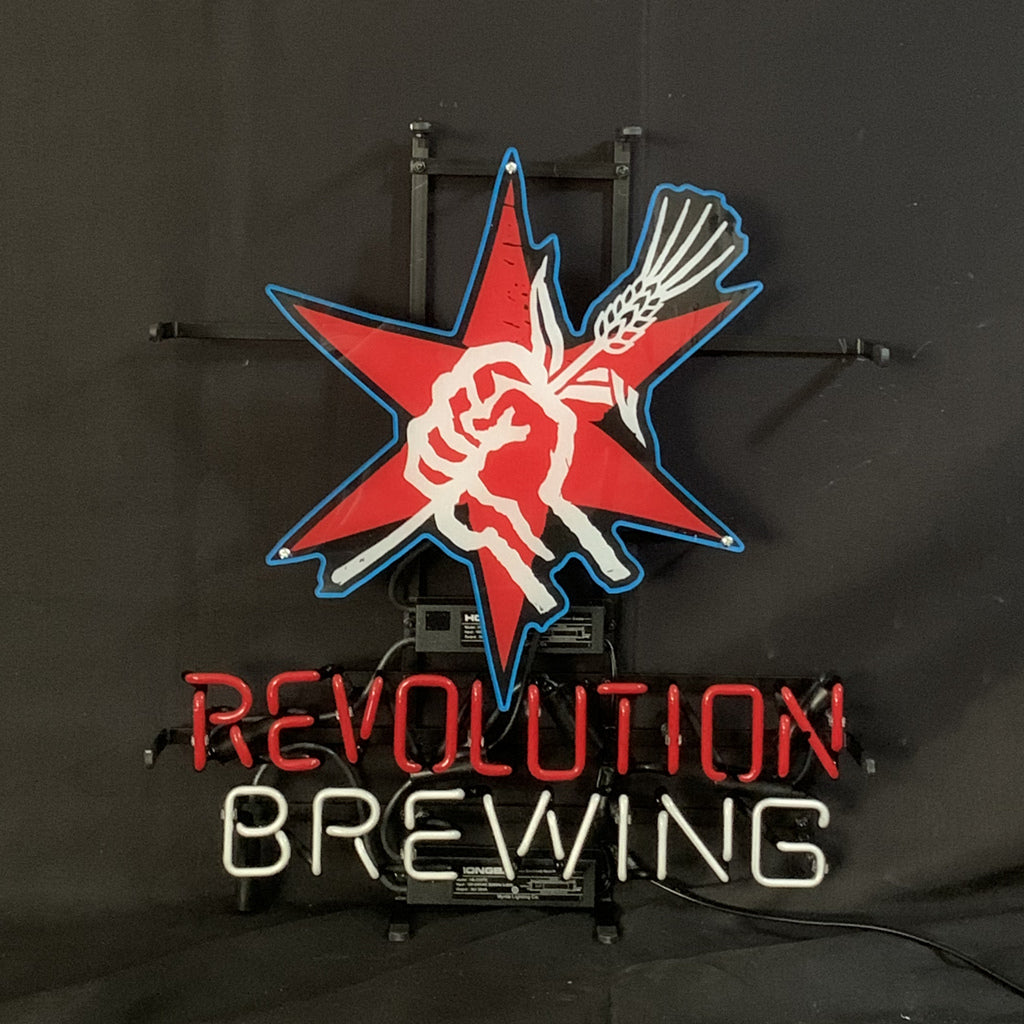 Neon sign with a red and blue star featuring a white fist holding a wheat stalk above red "REVOLUTION" and white "BREWING" text on a black background.