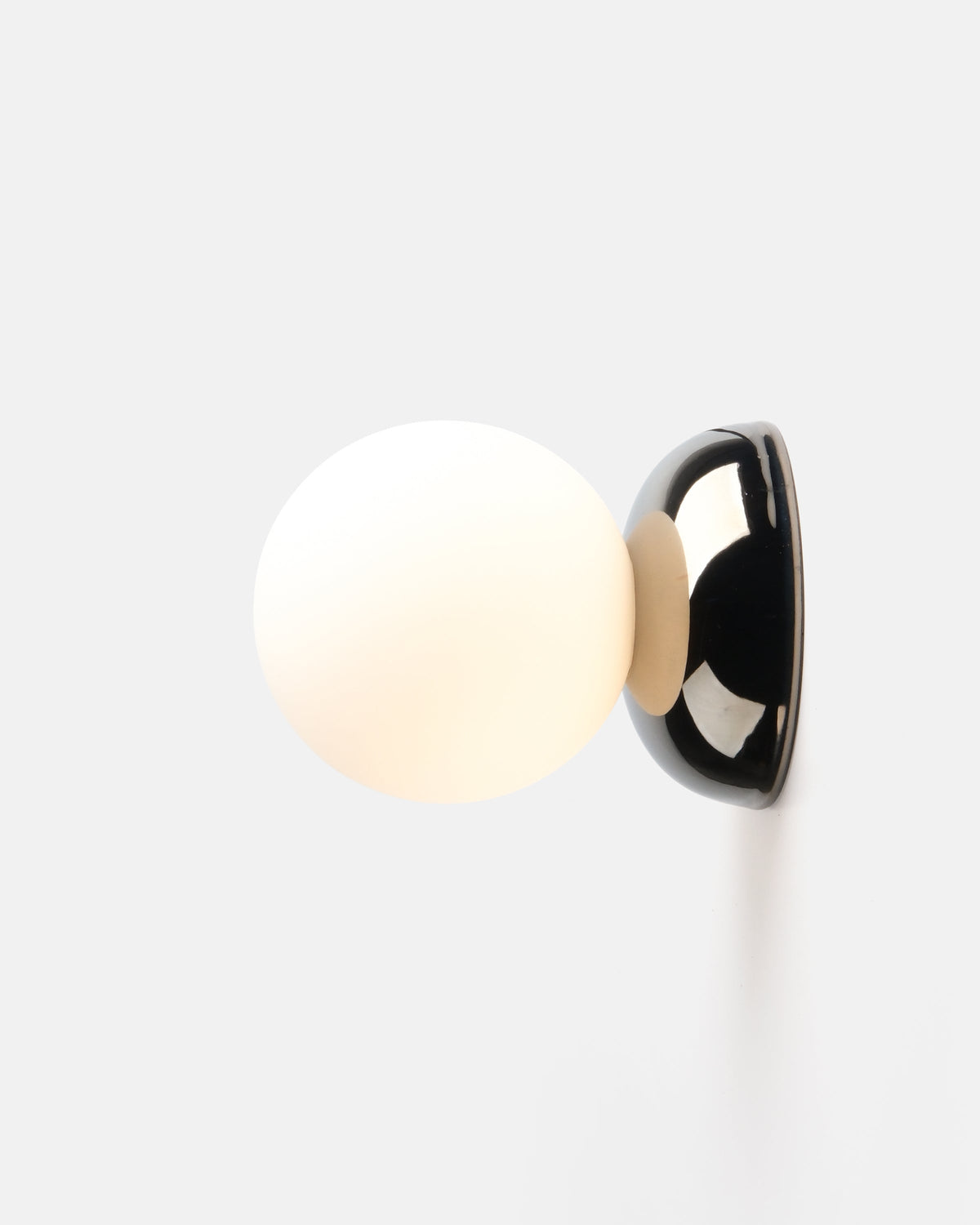 Ripple I Sconce by Misewell in chrome glaze mounted on a light wall