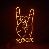 Orange neon light shaped like a hand making the rock sign with index and pinky fingers raised, with the word ROCK below in matching neon letters on black background.