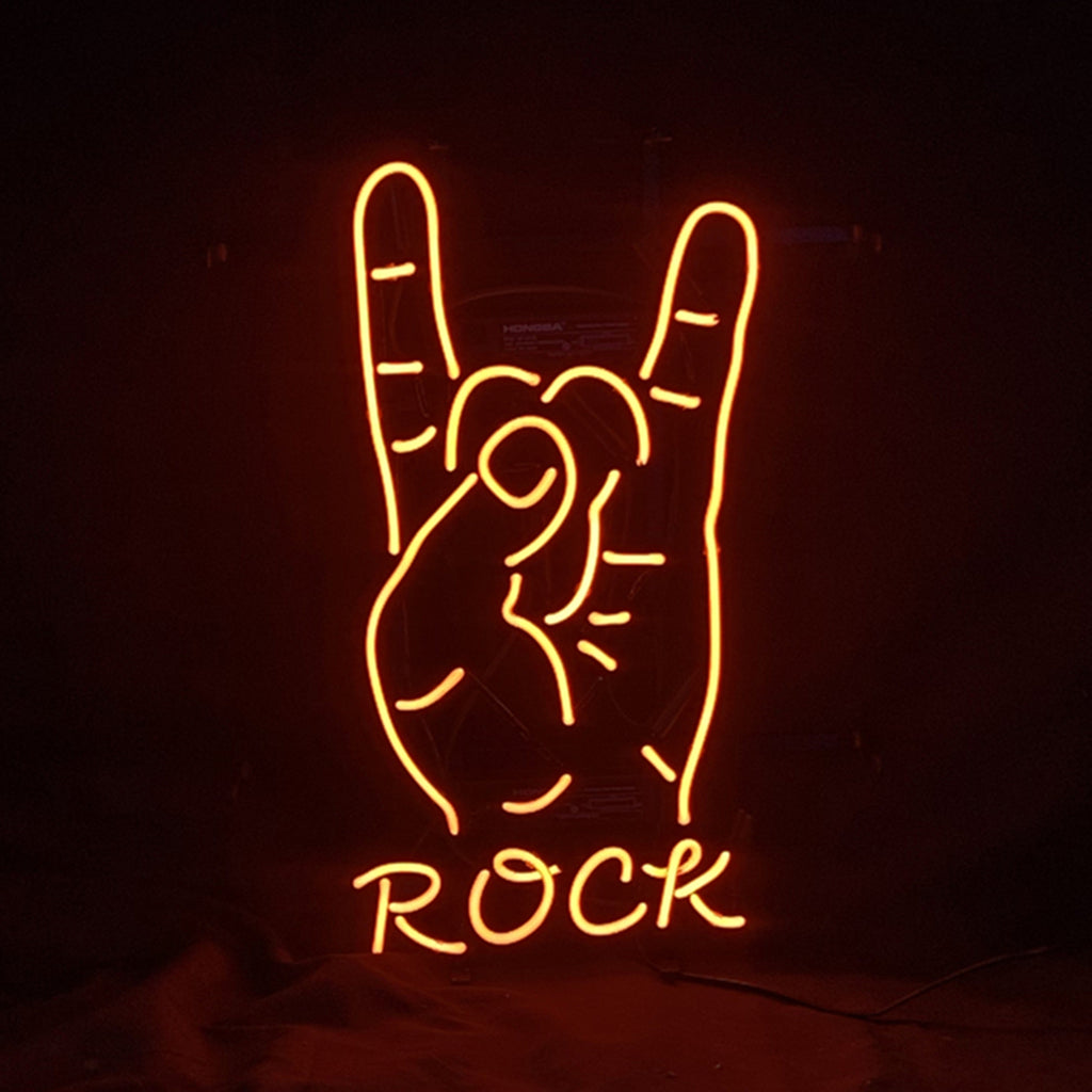 Orange neon light shaped like a hand making the rock sign with index and pinky fingers raised, with the word ROCK below in matching neon letters on black background.
