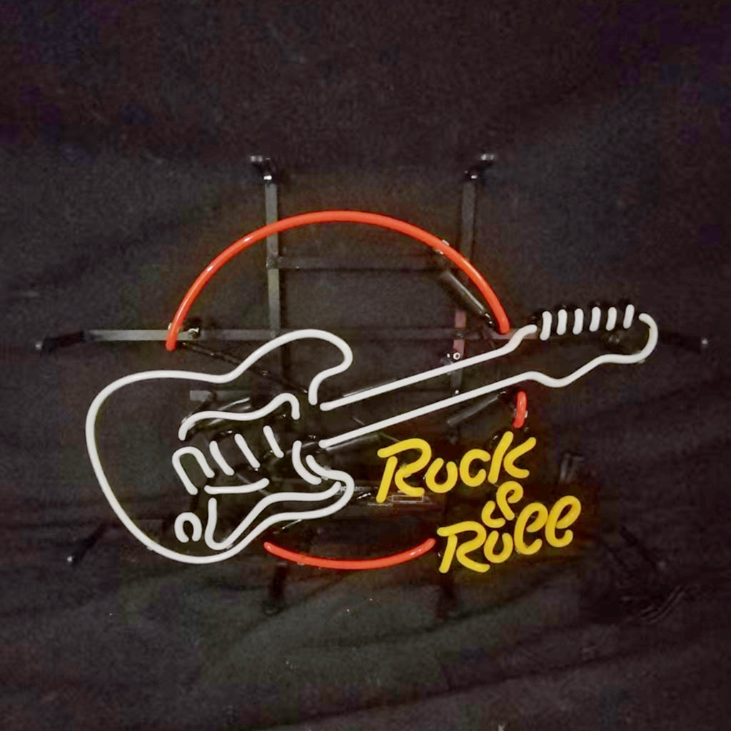 Neon sign of an outlined electric guitar in white and orange with the yellow text 'Rock & Roll' beneath it on a black background.