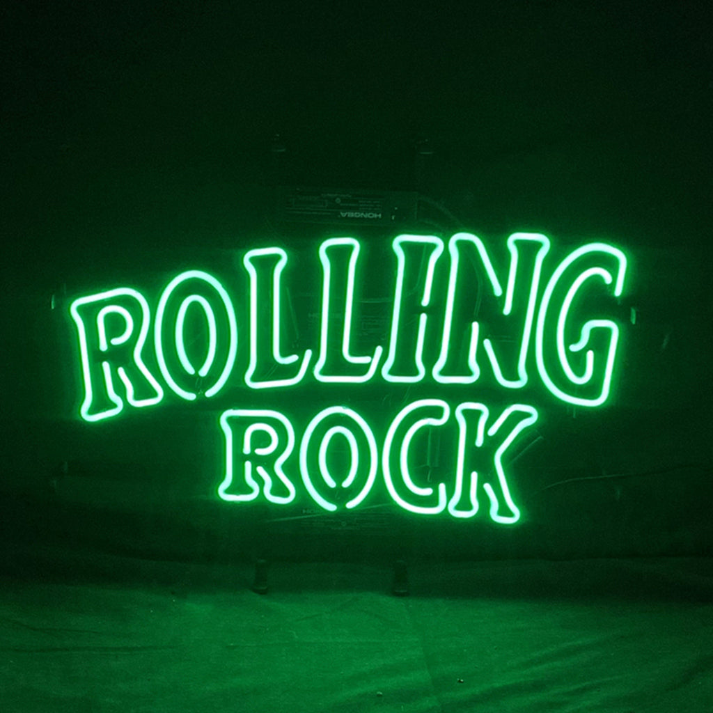 Rolling Rock Neon Light Sign glowing in warm amber light on a metal grid backing.