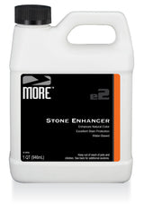 White 1-quart plastic jug with black lid labeled MORE e2 Stone Enhancer, featuring black and orange text panel describing natural color enhancement and stain protection.