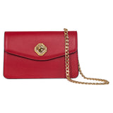Rectangular red leather clutch with flap closure featuring a central amber-colored Swarovski stone and a twisted gold chain strap draped to the side.