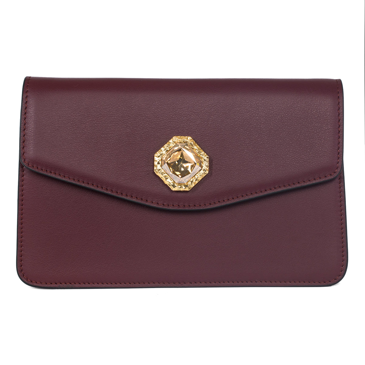 Bordeaux leather clutch with a rectangular flap and a central gold-toned hexagonal Swarovski stone accent on a white background