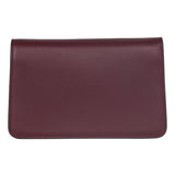 Rectangular Bordeaux-colored leather clutch with smooth texture and rounded bottom corners, shown flat against a white background.