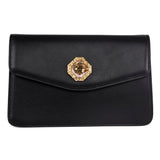 Black leather clutch with a flap closure featuring an octagonal custom gold-tone Swarovski stone emblem centered on the front.