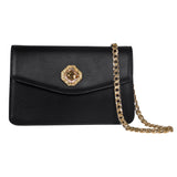 Black leather clutch with geometric gold-tone hexagonal clasp featuring a central Swarovski stone and a gold chain strap draped beside it.