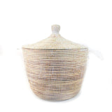 Rounded woven basket with a conical lid topped by a small knob, featuring white and natural beige fibers in a textured pattern.