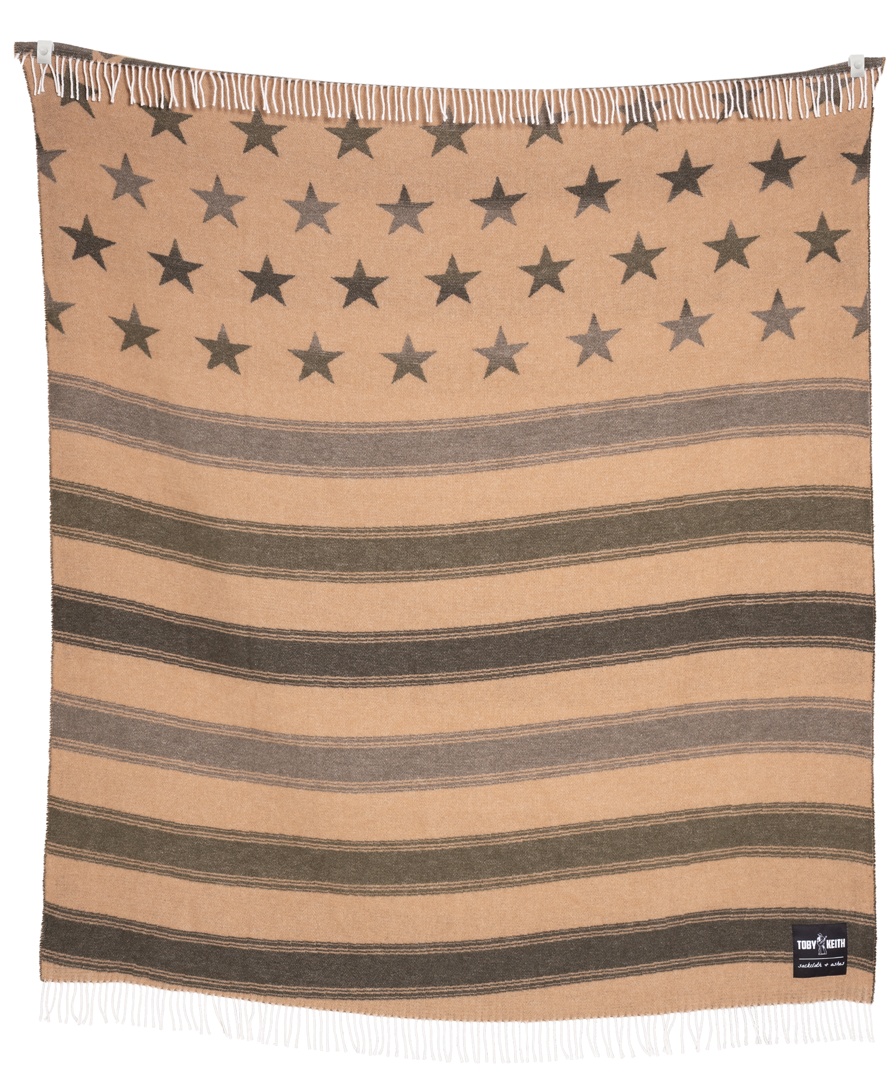 Toby Keith Valor blanket folded with patriotic pattern and warm neutral tones.