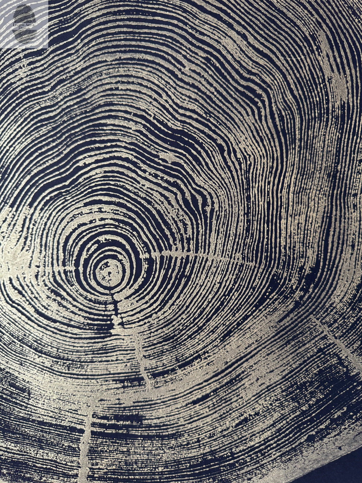 Close-up of artwork showing concentric growth rings and natural cracks of redwood, with a gold background and black rings highlighting wood texture.