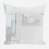 Square pillow featuring an abstract texture pattern in various shades of white and light gray, with visible brush strokes and rectangular shapes creating a layered effect.