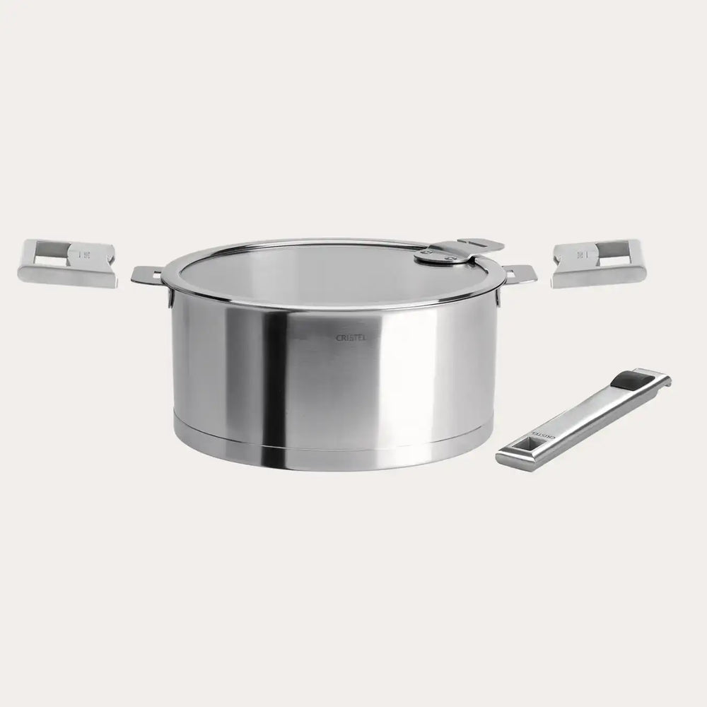 Stainless steel saucepan with lid and three detachable handles arranged around it on a light background.