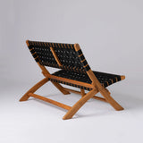 Low-profile bench with angular wooden frame and black woven straps forming the seat and backrest, shown at an oblique rear angle on white background.