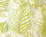 Close-up of pistachio green Mille Feuilles pillow cover featuring overlapping leaf patterns with light sage and cream accents on textured fabric.