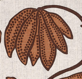 Close-up of an ochre floral design with dark brown dots and outlines on a beige fabric background, showing elongated petals and curved stems.