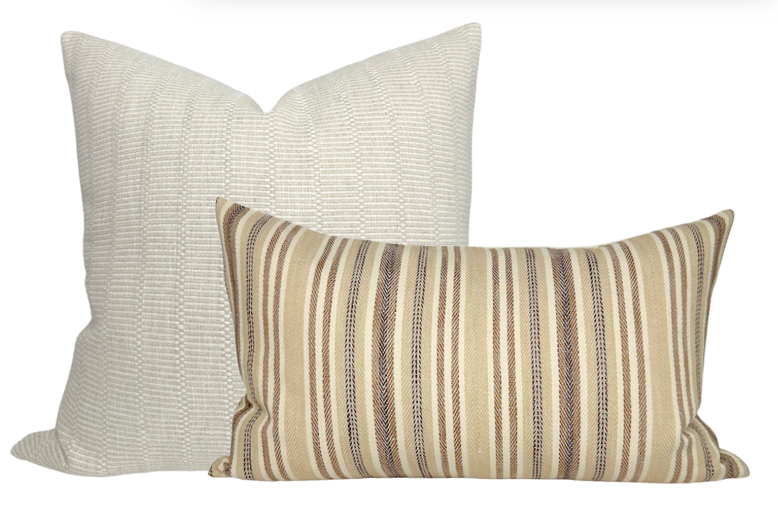 Two pillow covers: one square with textured off-white fabric, the other rectangular with tan, brown, and cream vertical stripes on woven fabric.
