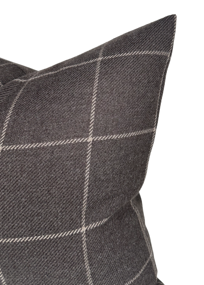 Close-up of a sable brown wool pillow cover with a subtle white windowpane check pattern and a textured woven surface.