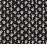 Close-up of black textile with repeating pattern of small cream-colored reed-like shapes and scattered dots by McLaurin + Piercy Textiles.