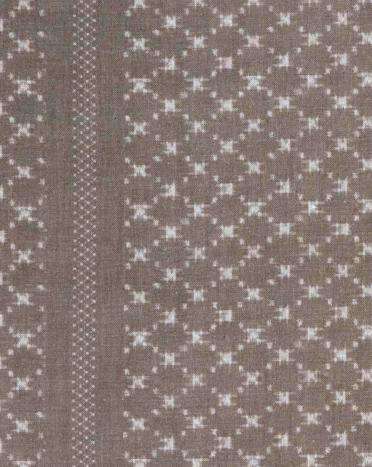 Earth grey fabric with a subtle geometric pattern of small white plus shapes and a vertical stripe of crisscross stitching on the left side.