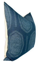 Rectangular pillow cover with deep indigo blue fabric front featuring irregular geometric medallion patterns in lighter blue tones and natural beige fabric back.