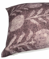 Close-up of a cotton pillow cover featuring a muted berry color with a botanical zinnia flower pattern in a slightly lighter shade.
