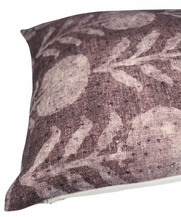 Close-up of a cotton pillow cover featuring a muted berry color with a botanical zinnia flower pattern in a slightly lighter shade.