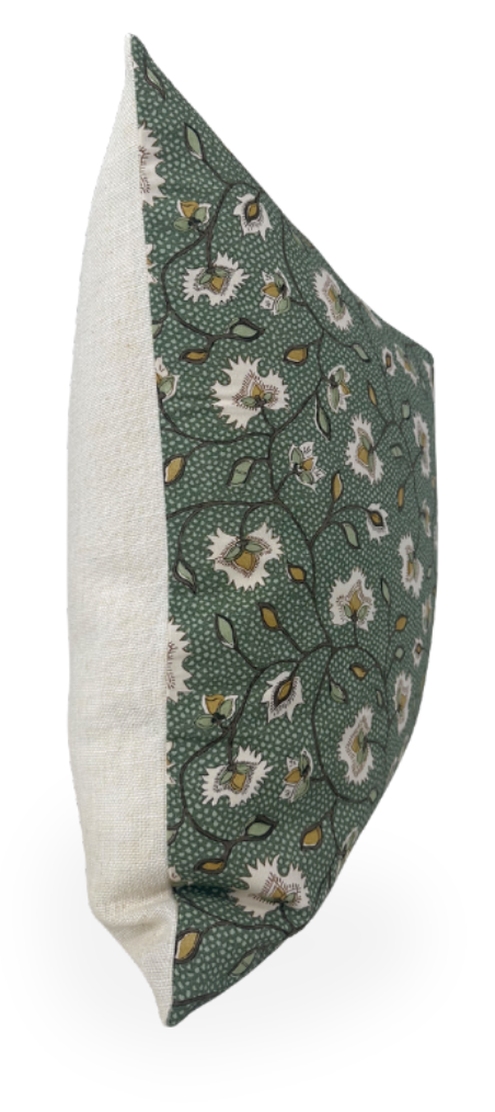 Side view of a pillow with a green fabric featuring white floral patterns and yellow accents, paired with a textured off-white fabric on the reverse side.