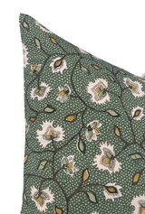 Corner of a Chelsea Pillow Cover in emerald green featuring stylized cream flowers with yellow and olive leaves connected by dark winding stems on a speckled green background.