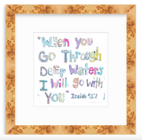 Watercolor text artwork with multicolored letters reading 'When you go through deep waters I will go with you' from Isaiah 43:2, framed in light wood with knot patterns.