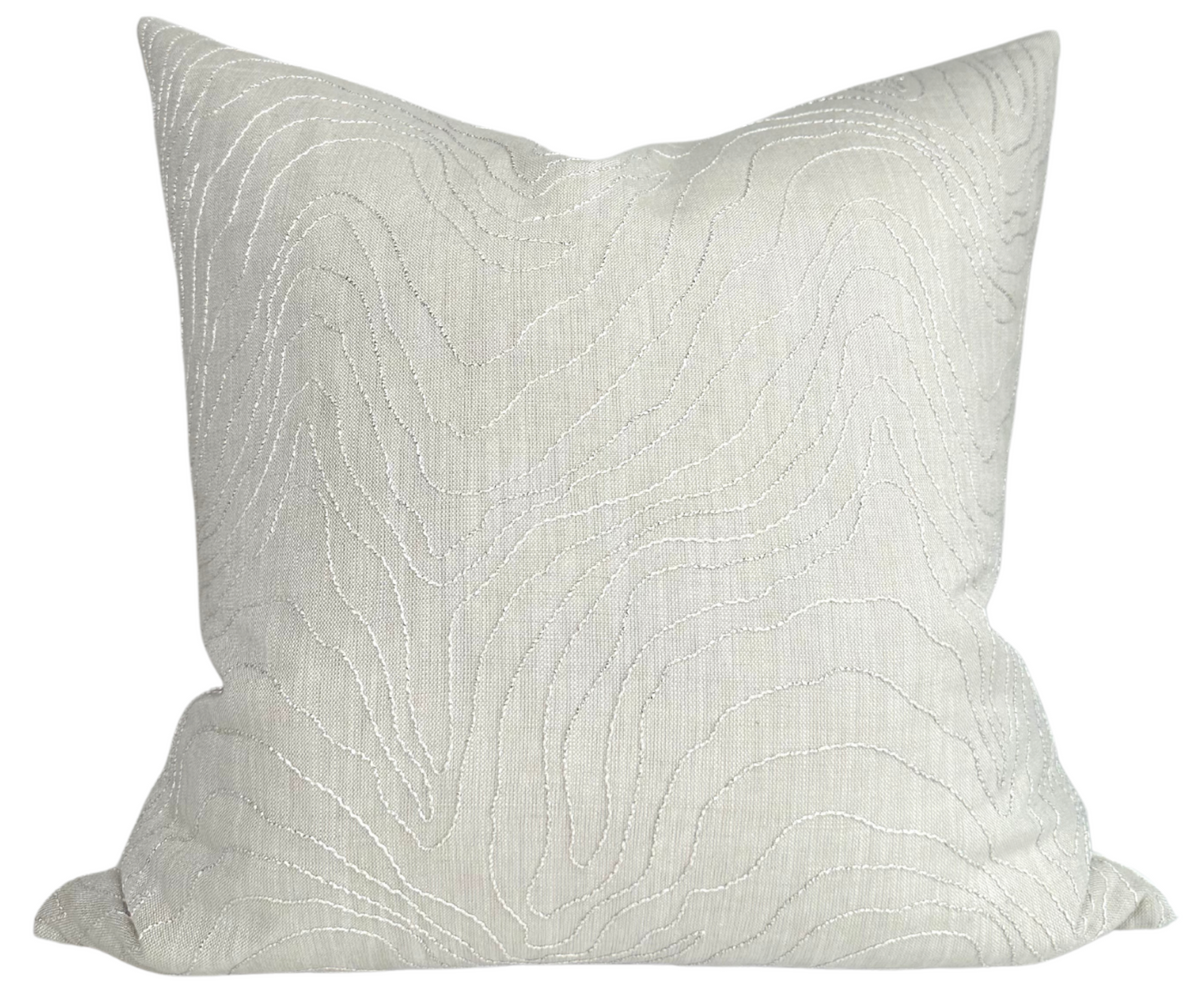 Formation Embroidered Pillow Cover in Oyster on a couch