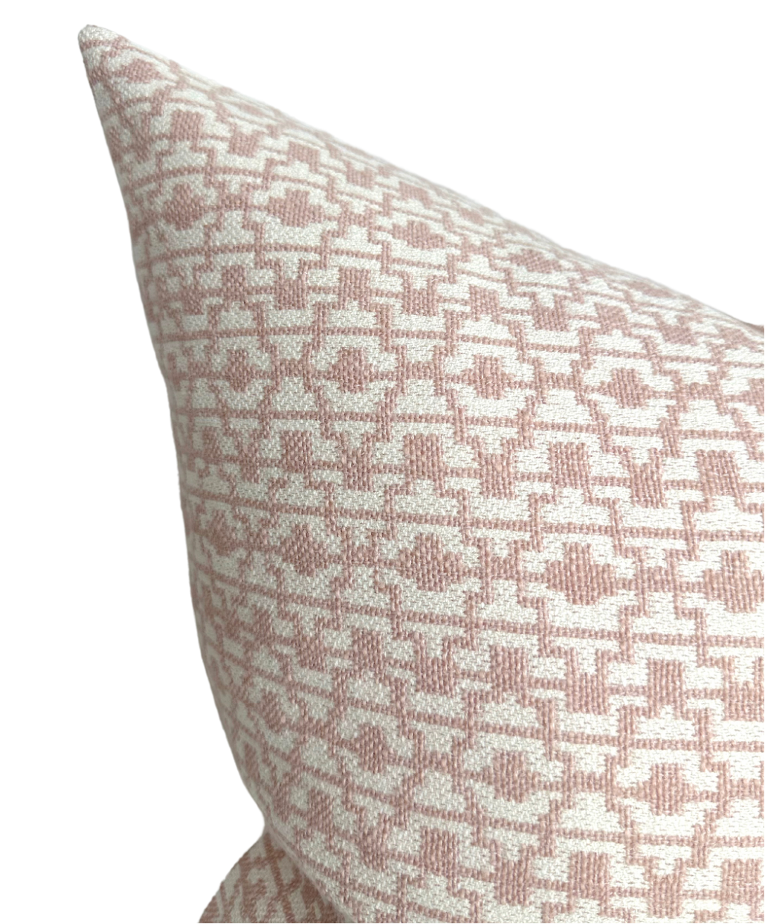 Close-up of a pillow cover featuring a geometric petal-colored pattern on a white background, showing detailed woven texture and sharp corner