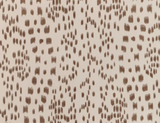 Tan brown irregular brushstroke spots arranged in a loose diamond pattern on a light beige background textile surface.