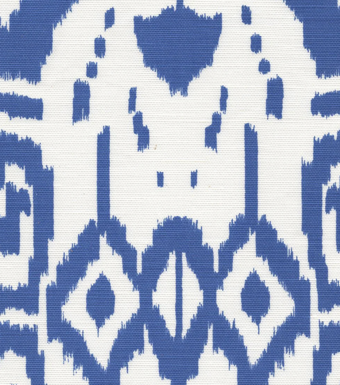 Close-up of Island Ikat pillow cover fabric with royal blue abstract geometric and diamond shapes on white background.